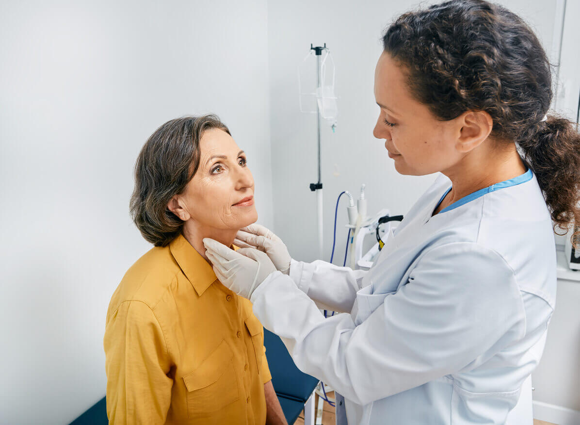 mature woman's neck for diagnostics of thyroid diseases and hypothyroidism at medical clinic