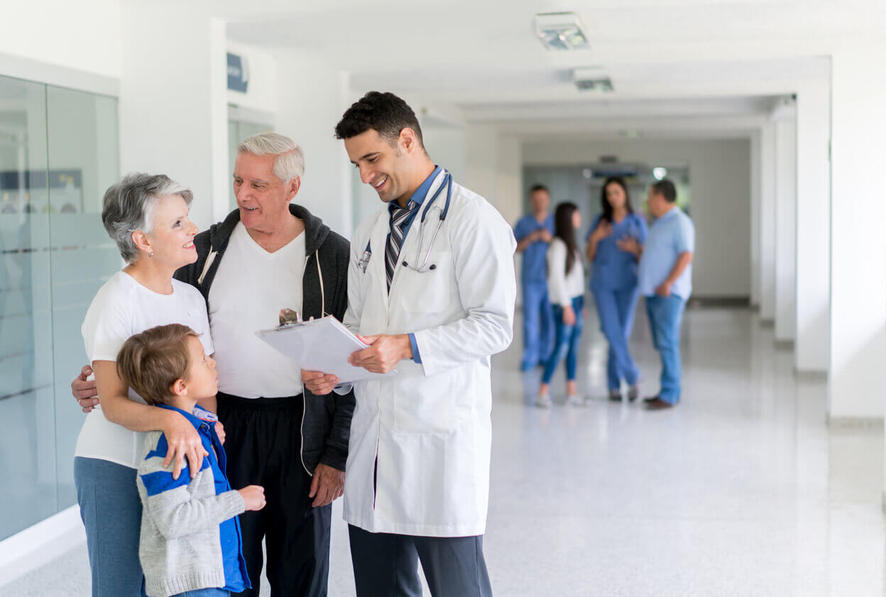 family practice physician talking to patients at the hospital