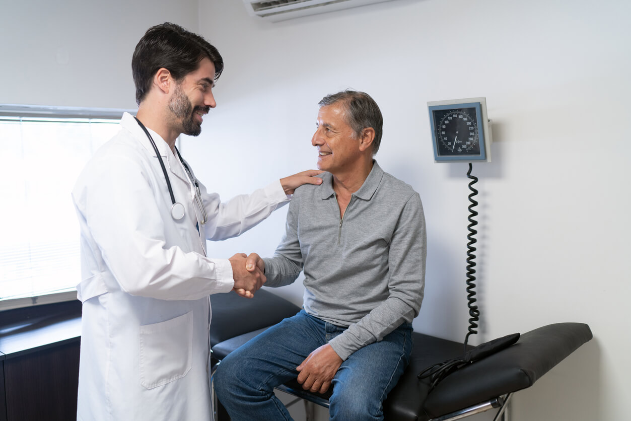 A male patient being seen by primary care practitioner for annual wellness check up.